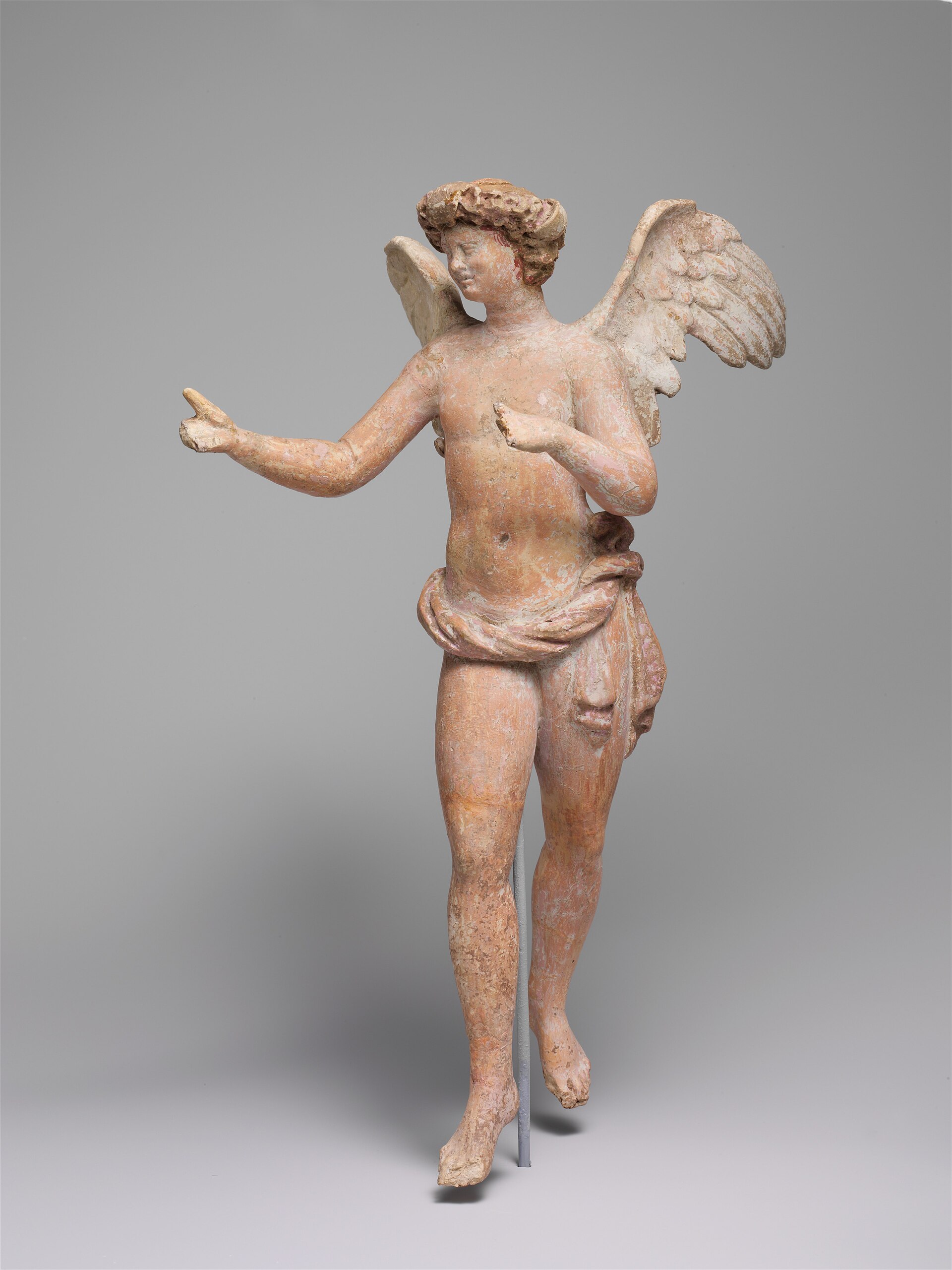Hellenistic terracotta of a winged adolescent Eros in flight, from Myrina.