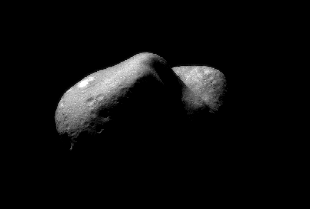 NEAR Shoemaker mosaic of asteroid 433 Eros, looking along its length across a gouge toward the far end.