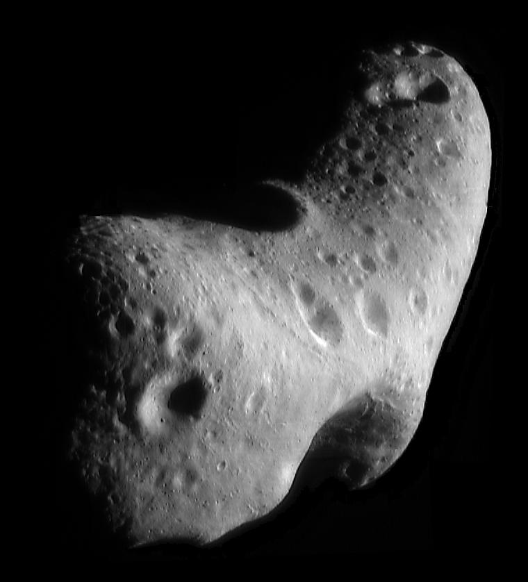 Mosaic of Eros looking down on the north polar region, with a saddle at the bottom, a large crater at the top, and a ridge running between them.